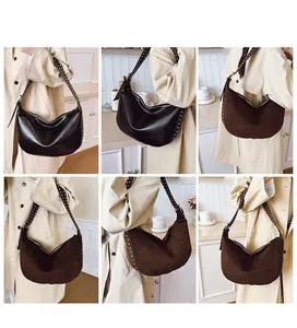 Detailed views of hobo bags in black leather and brown suede with silver metal rivets