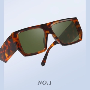 Close-up of retro tortoiseshell sunglasses with green square lenses and wide temples