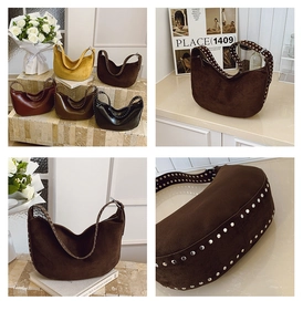 Detailed view of hobo bag with metal rivets in yellow brown and black suede texture