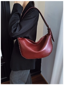 Close-up of the burgundy hobo bag with silver metallic rivet details on the strap