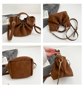 Close-up of brown bucket bag details showing textured gathers and golden ring handle