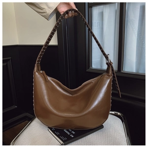 Detailed view of silver rivets on dark brown hobo bag with vintage motor style