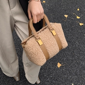 Winter beige plush teddy Boston bag with brown leather handles on ginkgo leaves