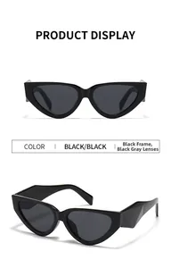 Detail view of black cat-eye sunglasses with geometric temples and dark lenses