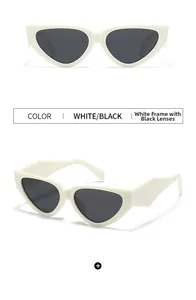 Detail view of narrow cat-eye sunglasses with thick white frames and dark grey lenses