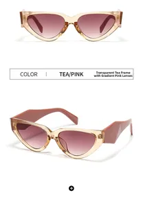 Close-up of tea-colored cat-eye sunglasses with gradient pink lenses and wide temples