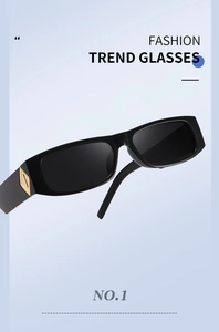 Detail of black square sunglasses featuring a golden geometric metal accent on the temple