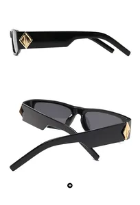 Macro shot of black square sunglasses featuring iconic gold diamond-shaped metal accents