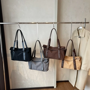 Minimalist large-capacity tote bags in black, gray, and brown with unique roll-top closures