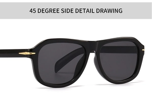 Close-up of 45 degree side detail with golden arrow metal decor on black sunglasses
