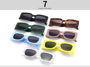 Flat lay of rectangle frame sunglasses in seven colors featuring gold star rivets