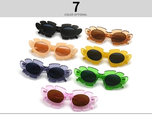 Detail showing seven vibrant colors of flower-shaped oversized fashion sunglasses