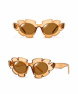 Macro view of amber petal-shaped sunglasses frames with wave design in translucent resin