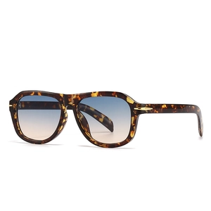 Retro oversized tortoiseshell sunglasses with blue gradient lenses and gold accents