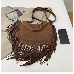 Detail of dark brown suede hobo bag with long bohemian tassels and adjustable strap
