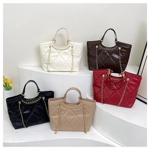 Detailed display of five quilted tote bags in white brown black khaki and red with gold chains
