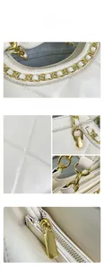 Close-up of beige quilted leather handbag featuring gold chain and metallic hardware