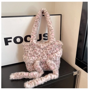 Detail of grey-pink leopard print plush shoulder bag with a 3D bow and soft faux fur texture