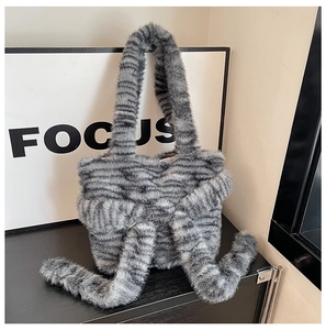 Detail of grey striped faux fur handbag with plush handles and unique long decorative tails