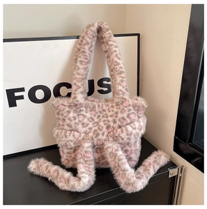 Macro view of plush leopard print faux fur handbag with ribbon bow detail