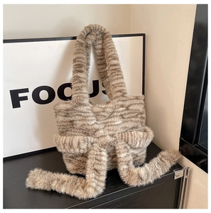Detail of soft striped faux fur plush tote bag with a decorative large bow
