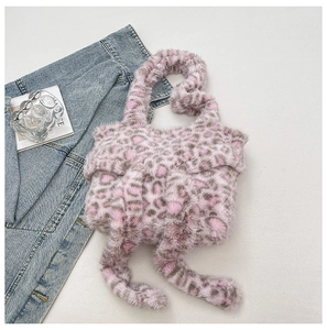 Macro shot of pink and brown leopard print faux fur texture with long fringe tassels