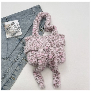 Detailed close-up of pink leopard print plush handbag with a large faux fur bow decoration
