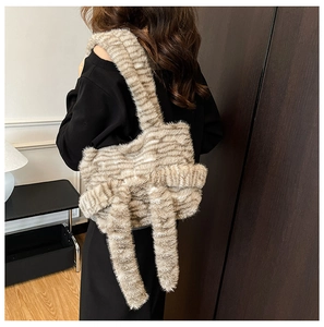 Detail of soft faux fur tote bag with striped texture and large plush bow decoration