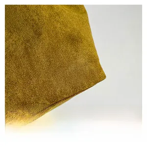 Macro detail of mustard yellow matte texture fabric with premium soft touch finish