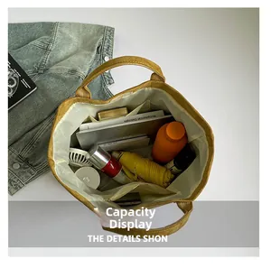 Top view of large mustard canvas tote bag showing interior compartments and daily essentials