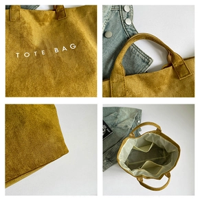 Detail view of large mustard yellow tote bag showing interior pockets and TOTE BAG print