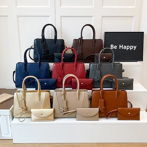 Chic commuter tote bag set in multiple colors with matching envelope clutch and handles