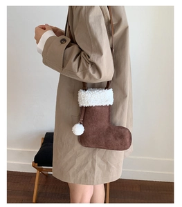 Detail of Christmas stocking crossbody bag in brown suede with white faux fur trim