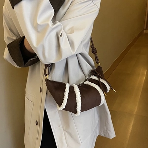 Brown croissant bag with white plush faux fur stripes and thin leather shoulder strap