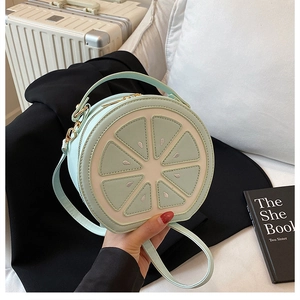 Detailed view of mint green lemon slice crossbody bag with sequins and metal zipper
