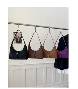 Four different colors of suede crescent underarm bags with metal buckle detail
