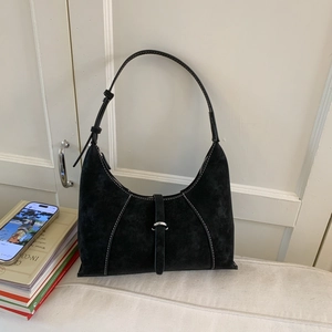 Detail showing white contrast stitching on black suede hobo bag with silver buckle