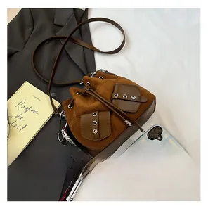 Detail of vintage brown frosted bucket bag with dual front pockets and plush bear charm