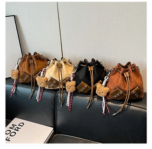 Four colors of suede bucket bags with leather drawstring and plush bear charms