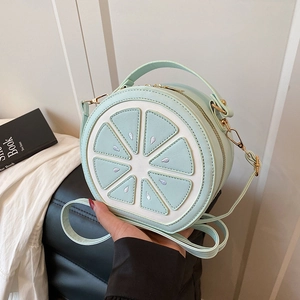 Mint green lemon slice round crossbody bag with leather strap and golden zipper detail