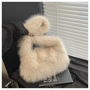 Detail of knot handle and fluffy faux fur texture on the beige tote bag