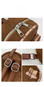 Dettaglio dello zaino in pelle scamosciata marrone con zip in metallo e toppa a stella