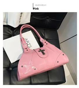 Detailed macro view of pink metallic leather shoulder bag with gothic cross ornament