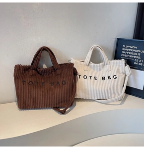 Detail of retro corduroy tote bags in brown and white with minimalist TOTE BAG text