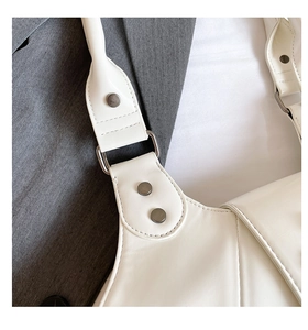 Detail of white leather handbag strap with matte grey metal rings and rivet studs