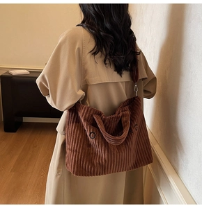 Detail of coffee corduroy tote bag showing textured fabric and adjustable shoulder strap