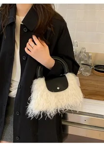 Detailed close-up of a plush white faux fur handbag with black leather flap and silver clasp
