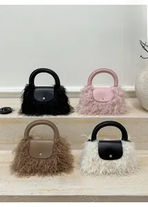 Detailed display of four mini faux fur handbags in black, pink, camel and bicolor styles