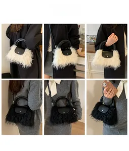 Detail of plush faux fur bags in black and white with leather handles and gold metal hardware