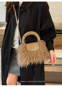 Brown shaggy plush handbag featuring a beige leather handle and retro minimalist style